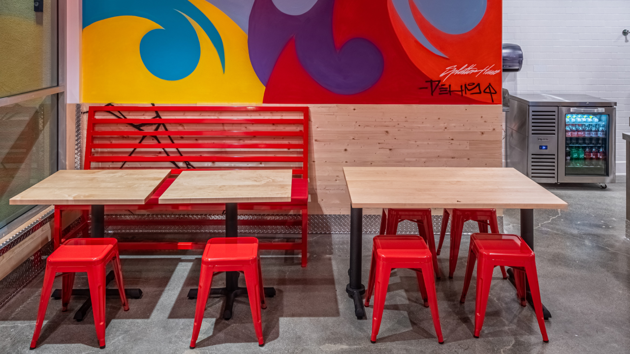 Image of bench seats and mural in dining room at Dave's Hot Chicken Costa Mesa, California on Harbor Boulevard