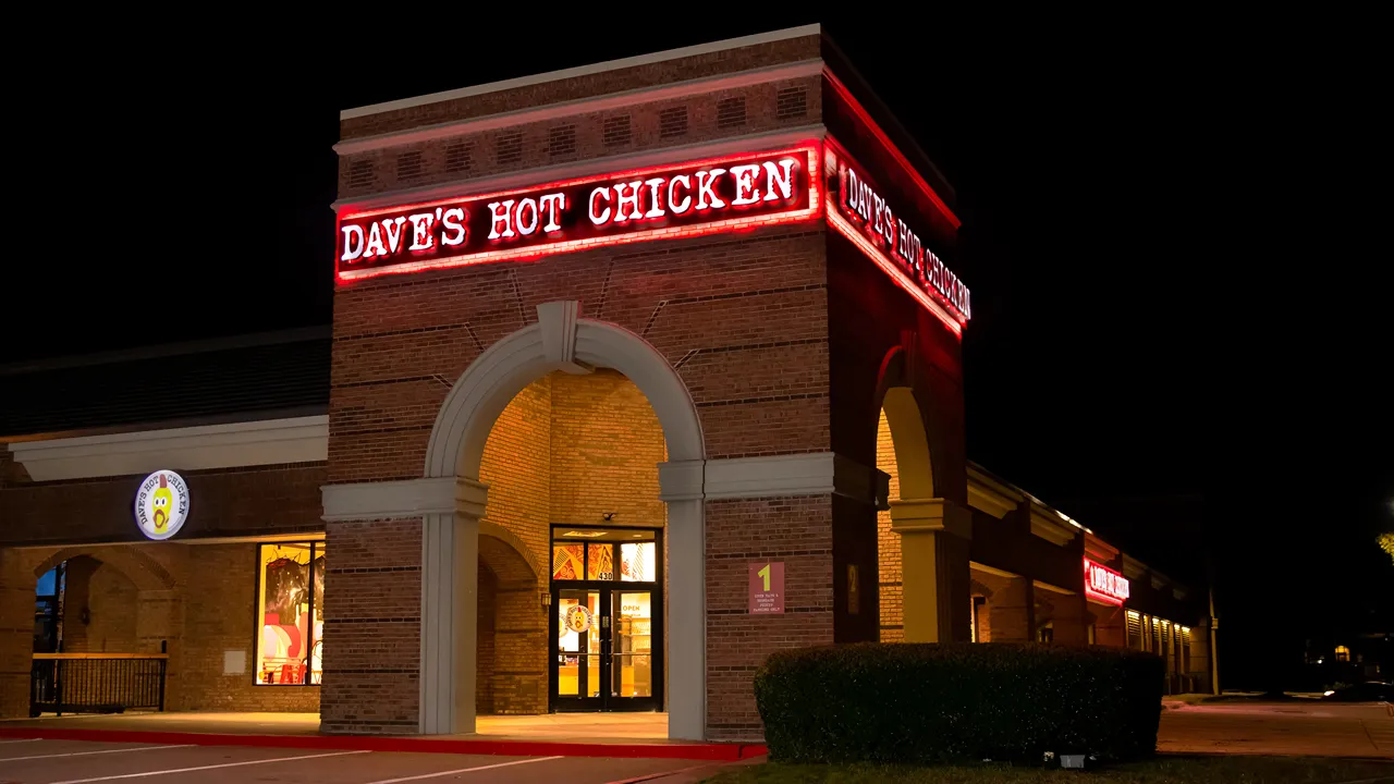 Exterior view of Dave’s Hot Chicken with red signage at Bryant Irvin in City View Center, Fort Worth, TX.