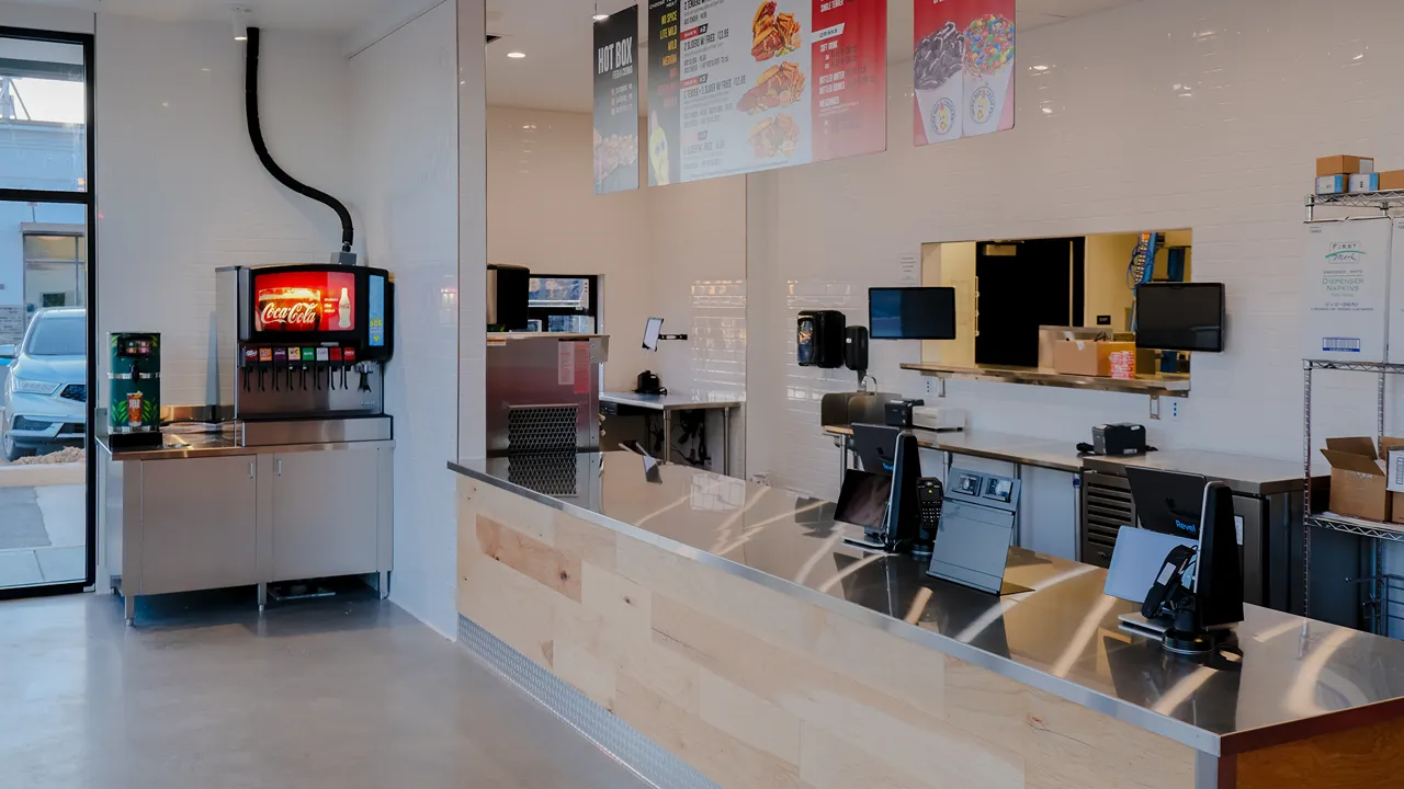 Dave's Hot Chicken ordering counter on Carlisle Pike, Mechanicsburg, PA, featuring a beverage station and stainless steel counters.