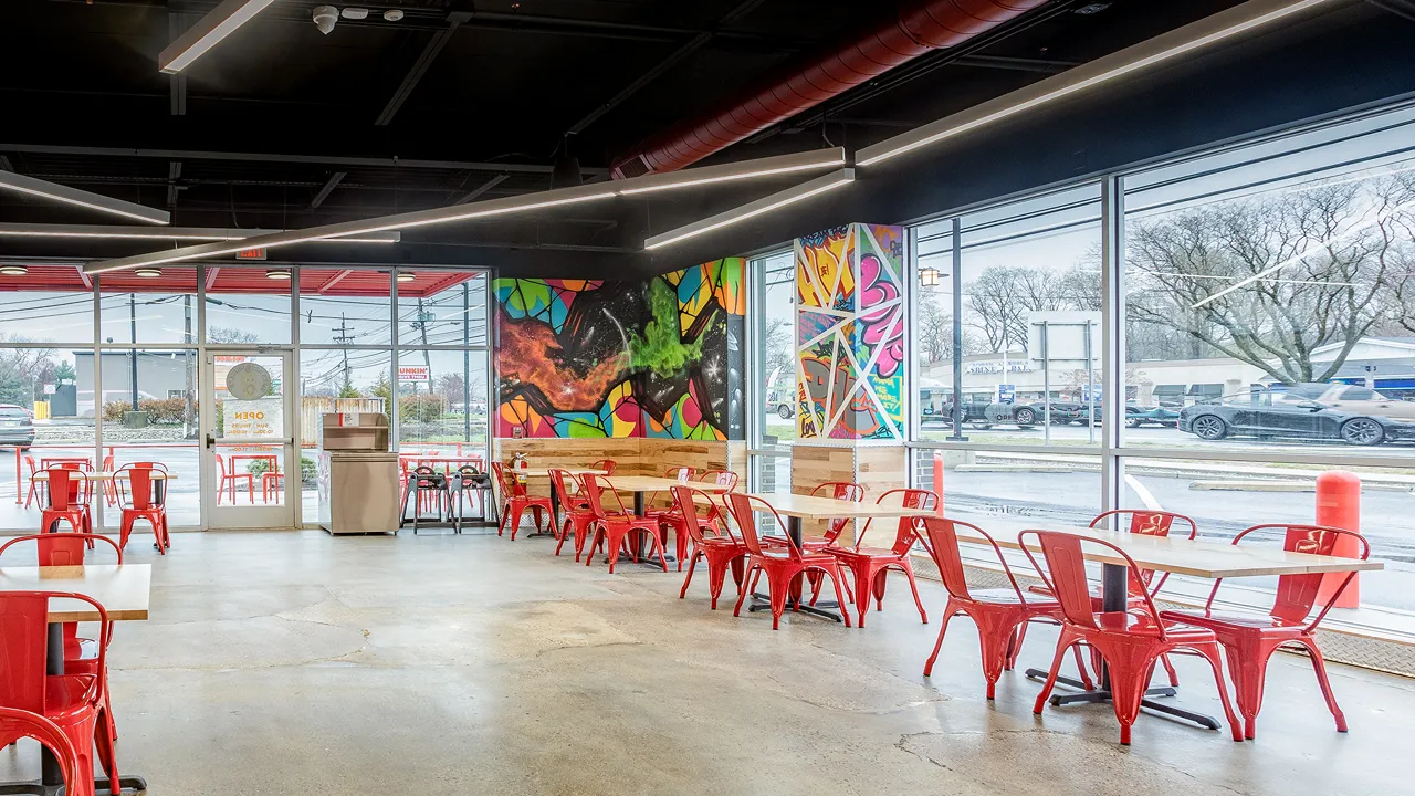 Dave's Hot Chicken Cherry Hill, NJ – Ellisburg interior view showing mural and large windows with street view.