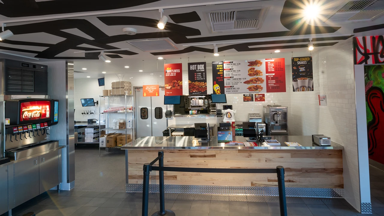 Dave's Hot Chicken counter and menu in Apple Valley, MN, with drink station and visible menu boards.