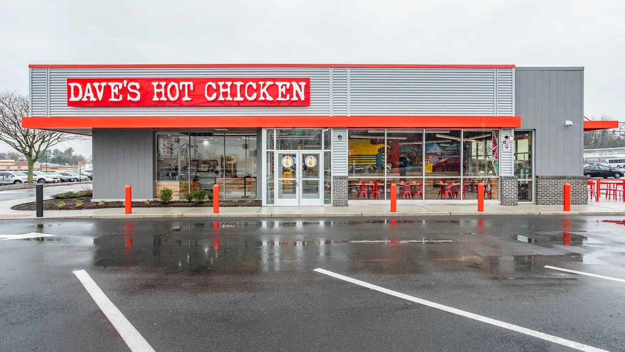 Dave's Hot Chicken Cherry Hill, NJ – Ellisburg front entrance with bright red sign and outdoor seating.