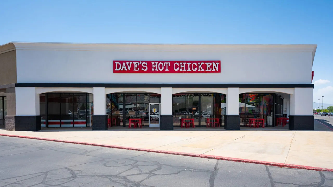 Front view of Dave’s Hot Chicken in Orem, Utah, on E. University Pkwy, with the store’s bold signage and exterior seating.