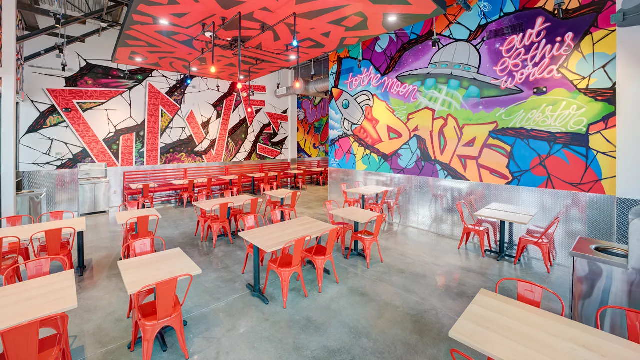 Interior graffiti wall art and seating area at Dave's Hot Chicken, Eastfield Dr, Webster, TX, Baybrook location.