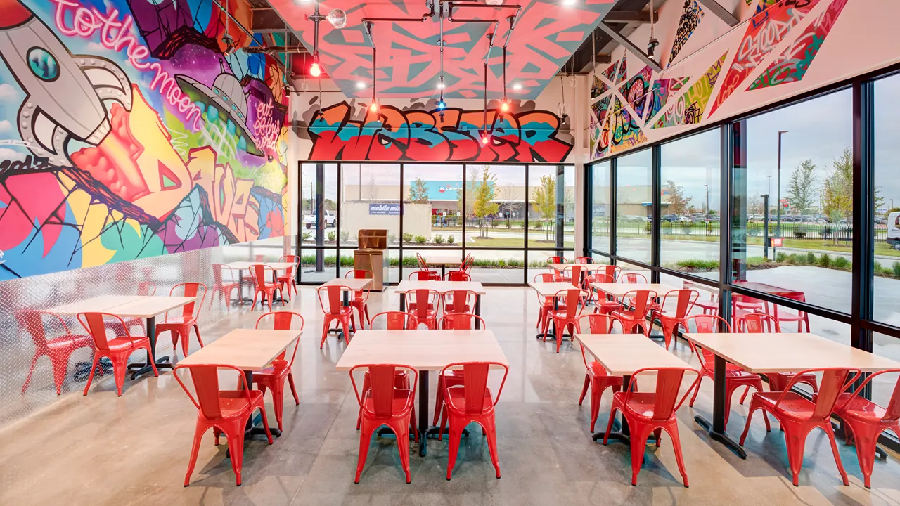 Wide view of the seating area with large windows at Dave's Hot Chicken, Eastfield Dr, Webster, TX, Baybrook.