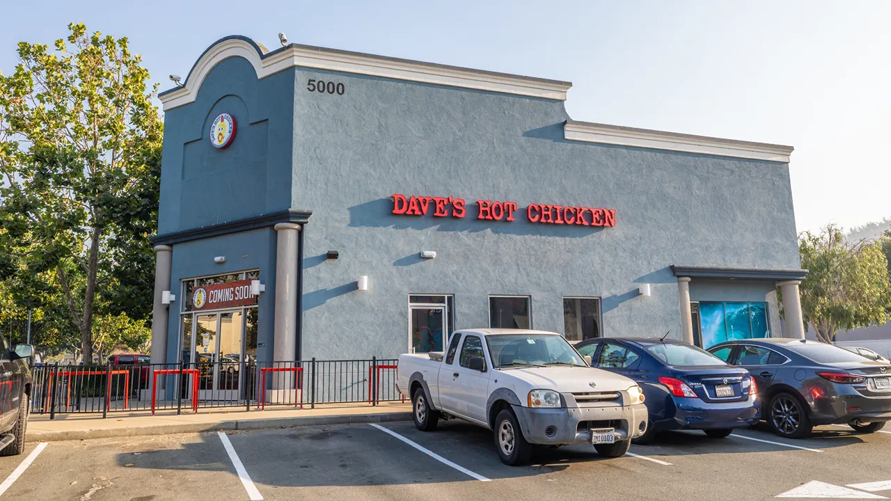 Exterior of Dave's Hot Chicken, showing the entrance and parking lot in El Cerrito Plaza El Cerrito, CA.