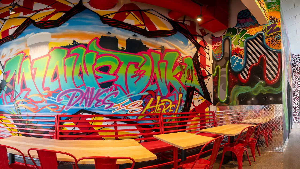 Vibrant mural featuring Minnetonka-themed street art inside Dave's Hot Chicken on Plymouth Rd, Minnetonka, MN.