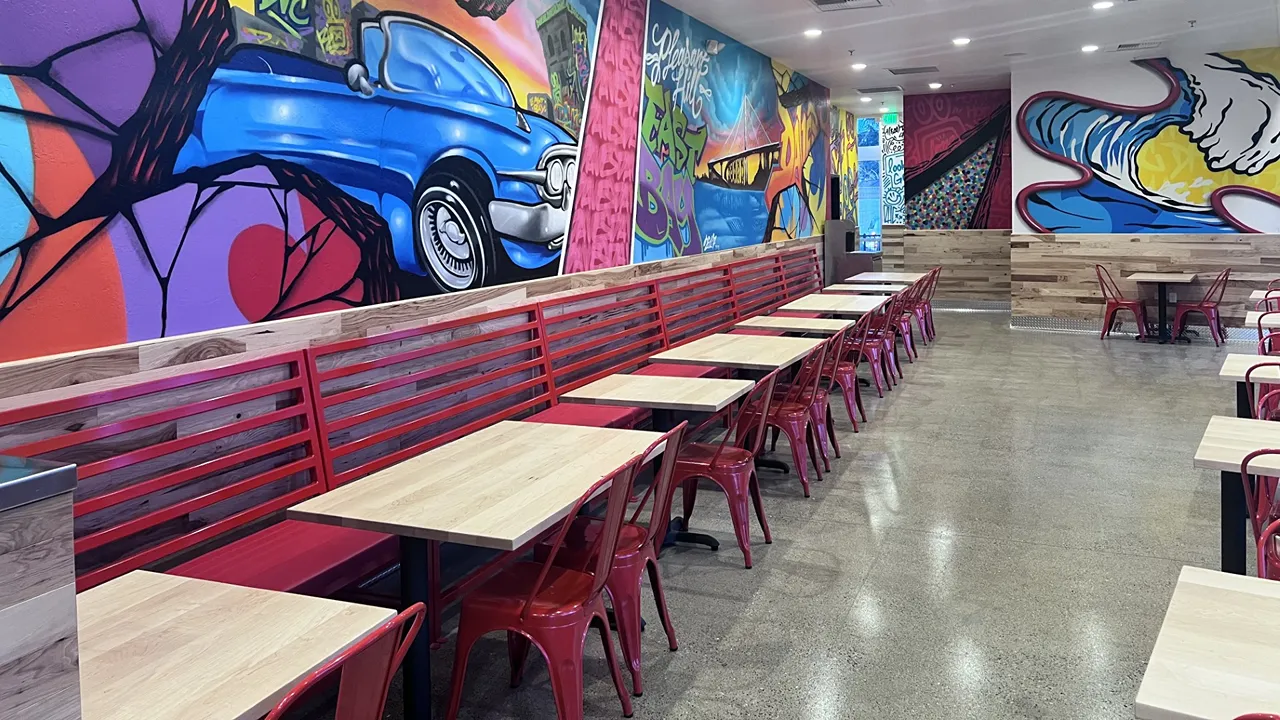 Interior view with booth seating and wall art at Dave's Hot Chicken on Monument Blvd, Pleasant Hill, CA.