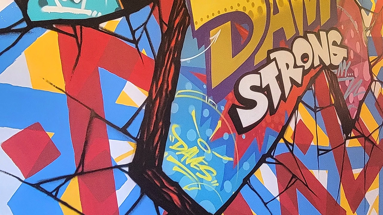 Vibrant mural inside Dave's Hot Chicken in Amsterdam, NY, featuring colorful designs and bold text saying 'Dave's Strong.