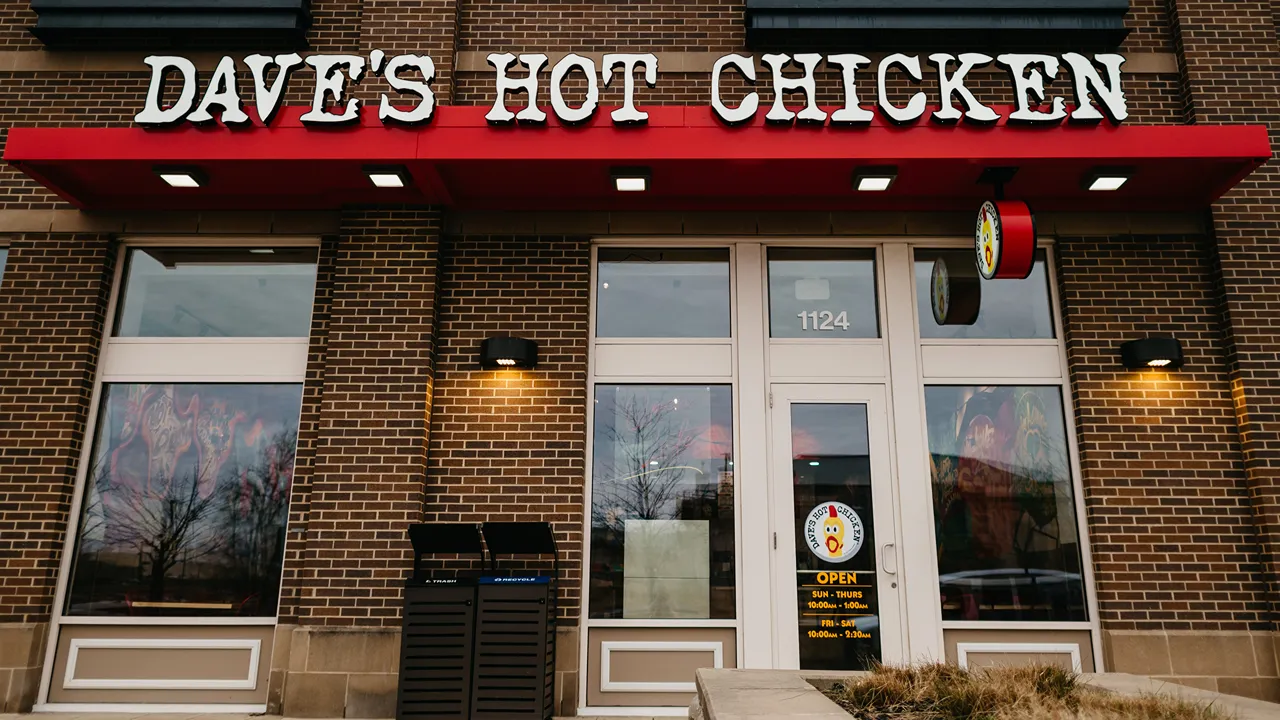 Exterior view of Dave's Hot Chicken location on N. Eddy St., South Bend, IN, featuring a brick facade with the restaurant's signage.