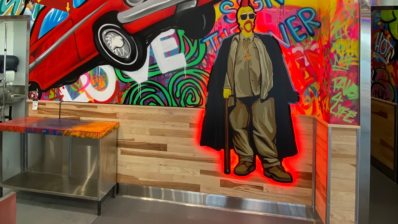 Interior of Dave's Hot Chicken in N Victory Pl, Burbank, CA, featuring graffiti art, saying I love chicken graphically.