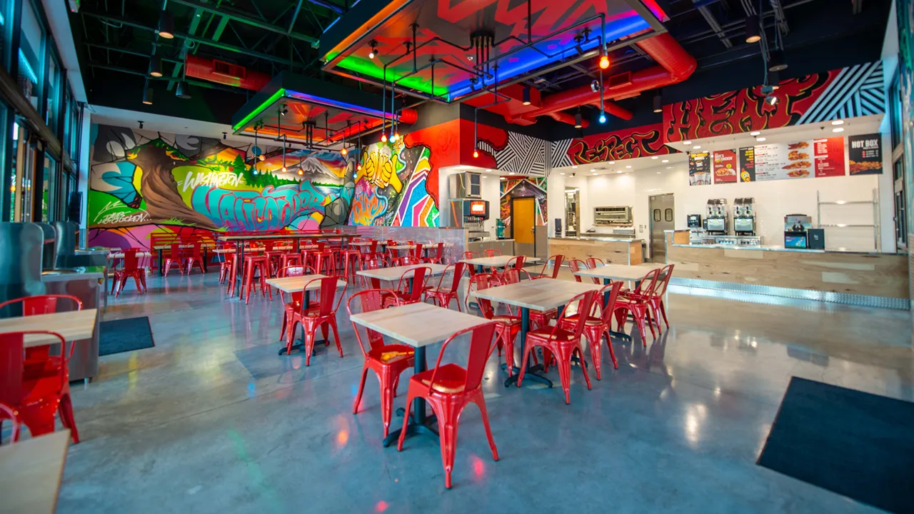 Wide view of the colorful interior and seating area at Dave's Hot Chicken on NE 6th Ave, Vancouver, WA - Hazel Dell location.