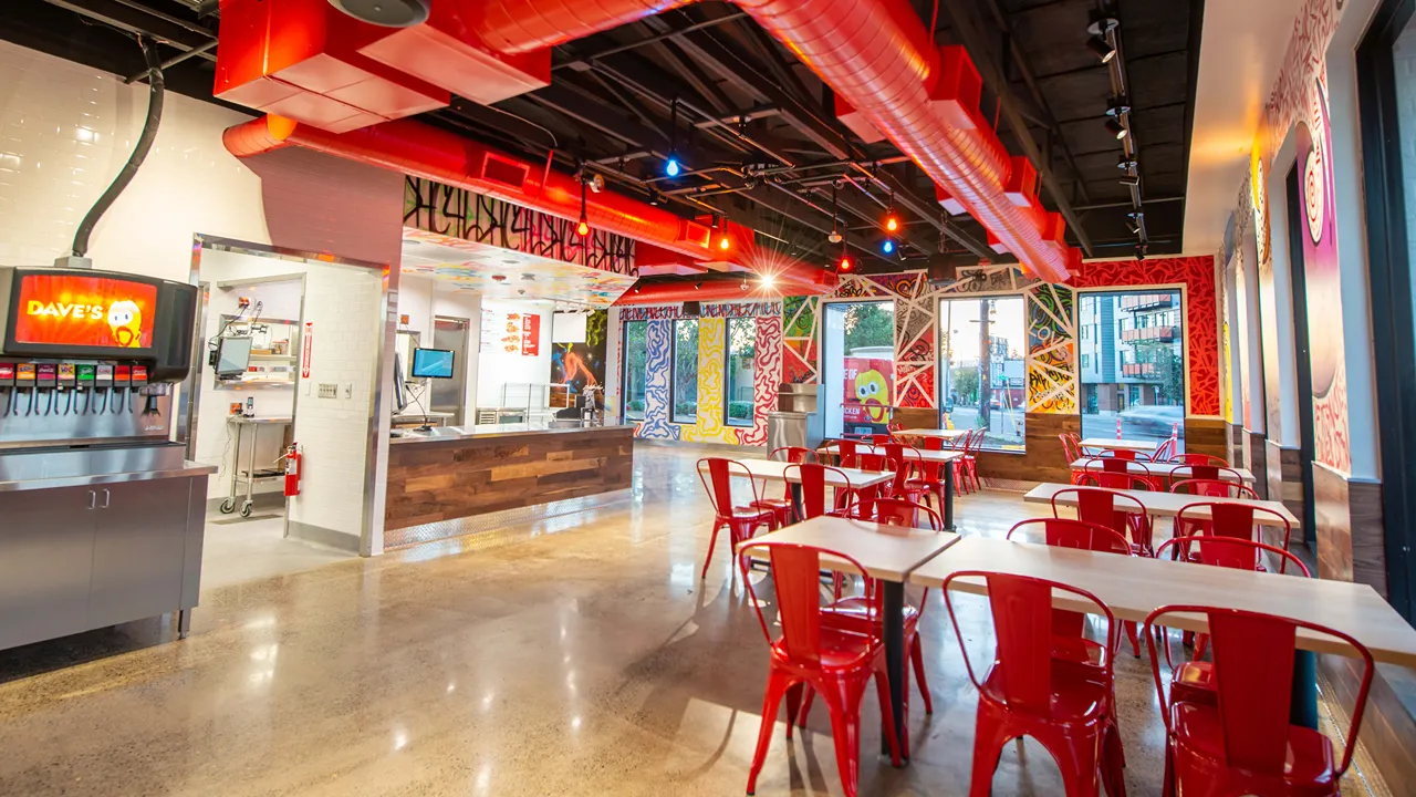 Counter area of Dave's Hot Chicken on NE Sandy Blvd, Portland, OR, showcasing the soda fountain and ordering area, with vibrant wall designs.