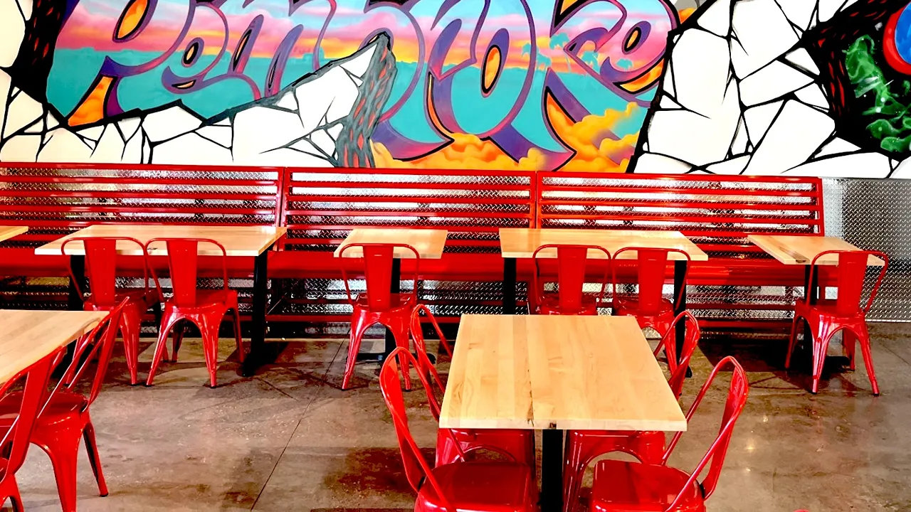 Bright and bold wall art with graffiti spelling “Pembroke” inside the dining area of Dave’s Hot Chicken on Pines Blvd, Pembroke Pines, FL - West Fork.