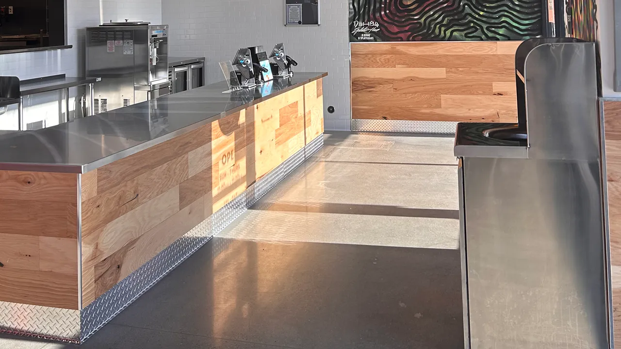 Service counter with stainless steel top and wooden accents at Dave's Hot Chicken, S. Yuma Palms Pkwy, Yuma, AZ.