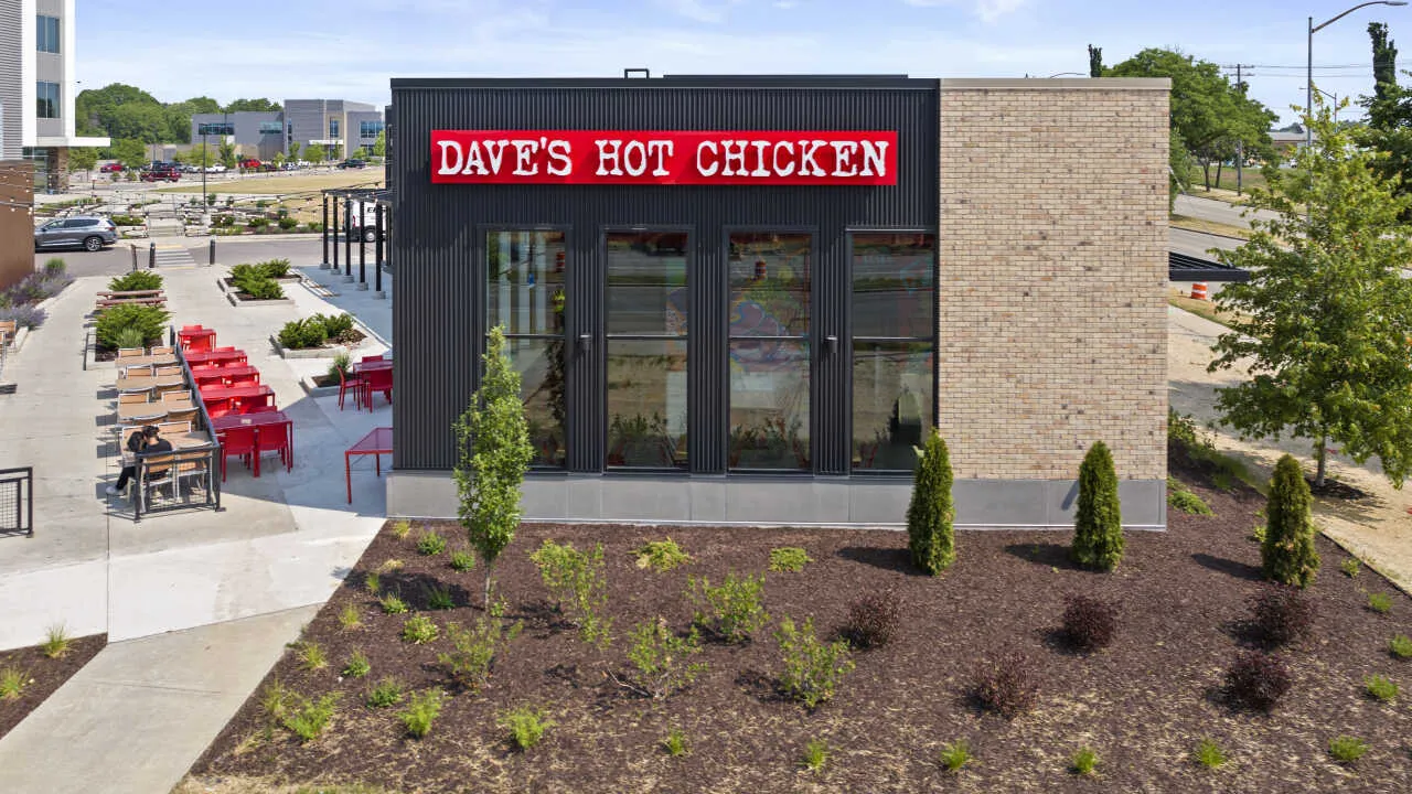 View of the Restuarant with new landscaping and outdoor seating area with string lights at Dave's Hot Chicken on Sligo Drive, Madison, WI.