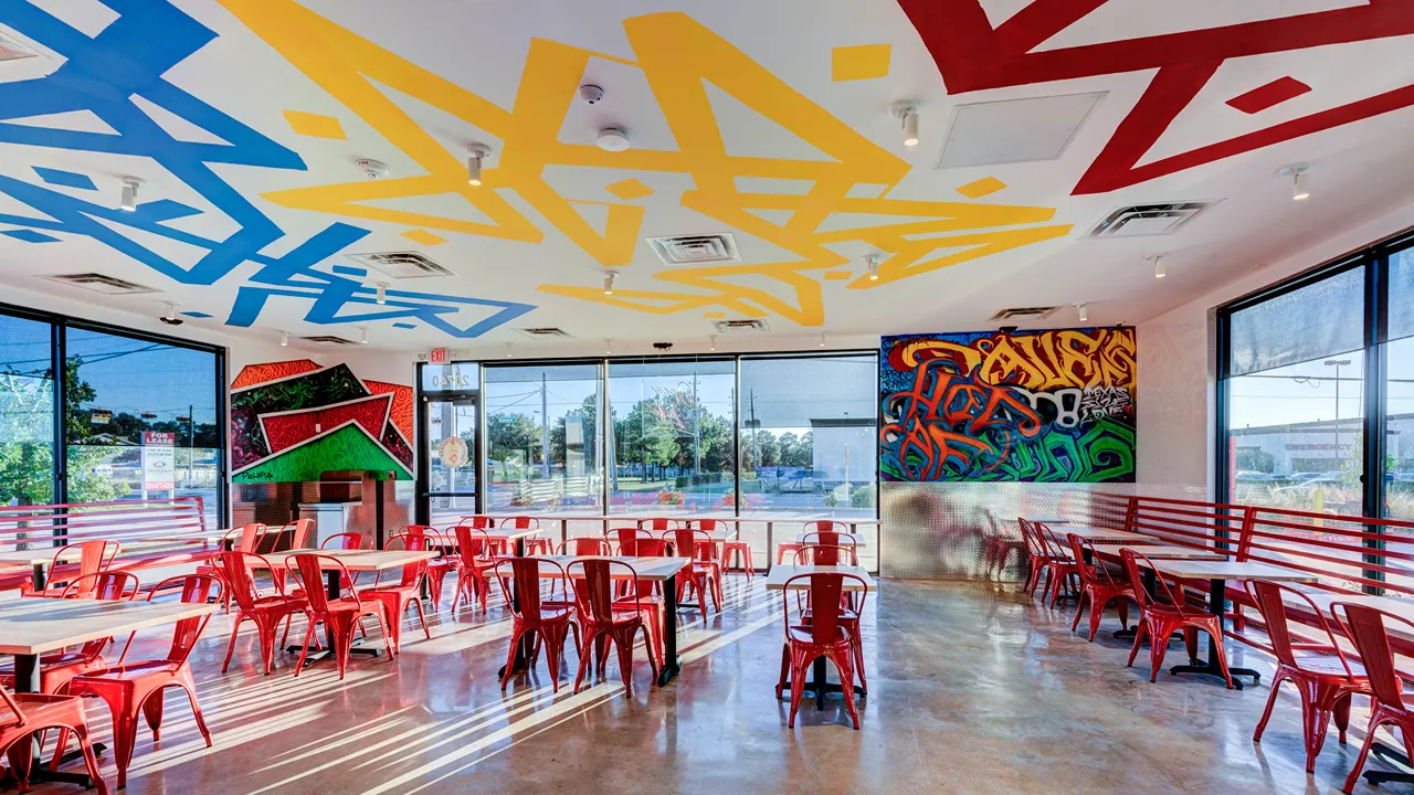 Counter area with menus displayed and seating area at Dave's Hot Chicken, Kuykendahl Road, Spring, TX.