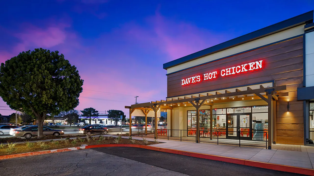 Evening exterior shot of Dave's Hot Chicken on Temecula Pkwy, Temecula, CA, with the restaurant lit up against a twilight sky.