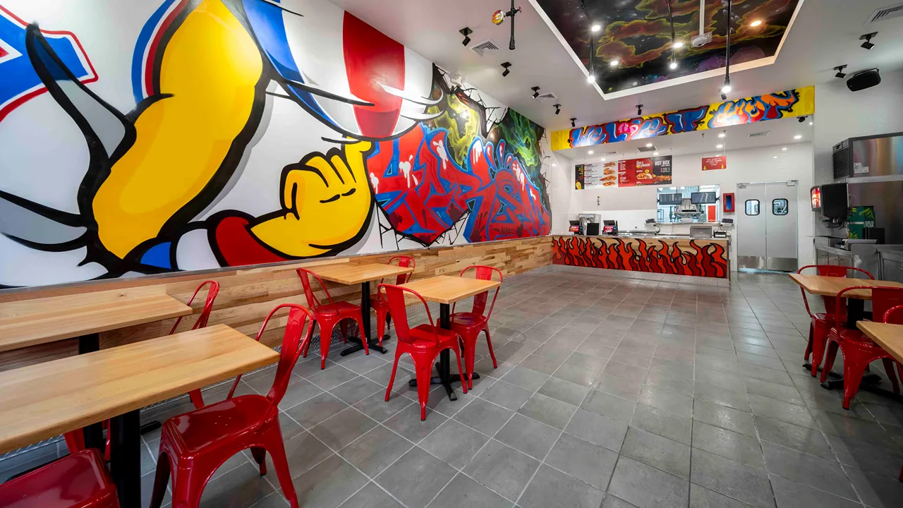 View of counter and seating with flame mural at Dave’s Hot Chicken, W. 125th St., Harlem, New York, NY.