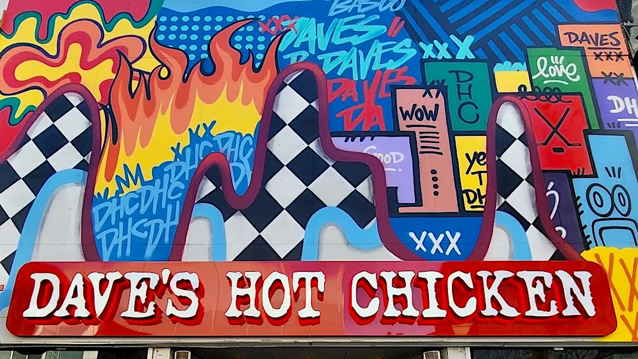 Exterior view of Dave's Hot Chicken with vibrant mural at Yonge & Dundas, Toronto, ON.