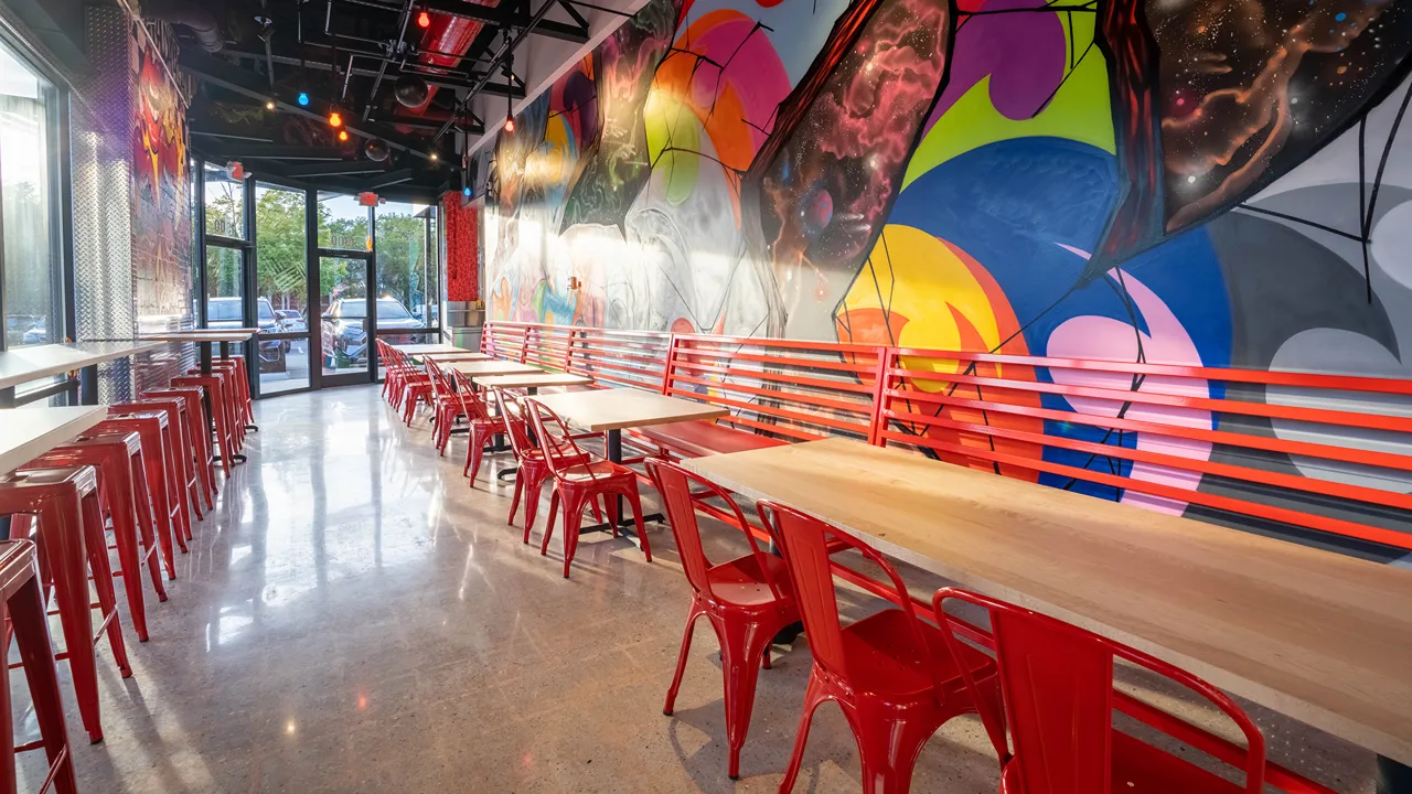 Entrance area with seating and vibrant murals at Dave's Hot Chicken, 1300 The Plaza, close to Central Avenue in Charlotte, NC.