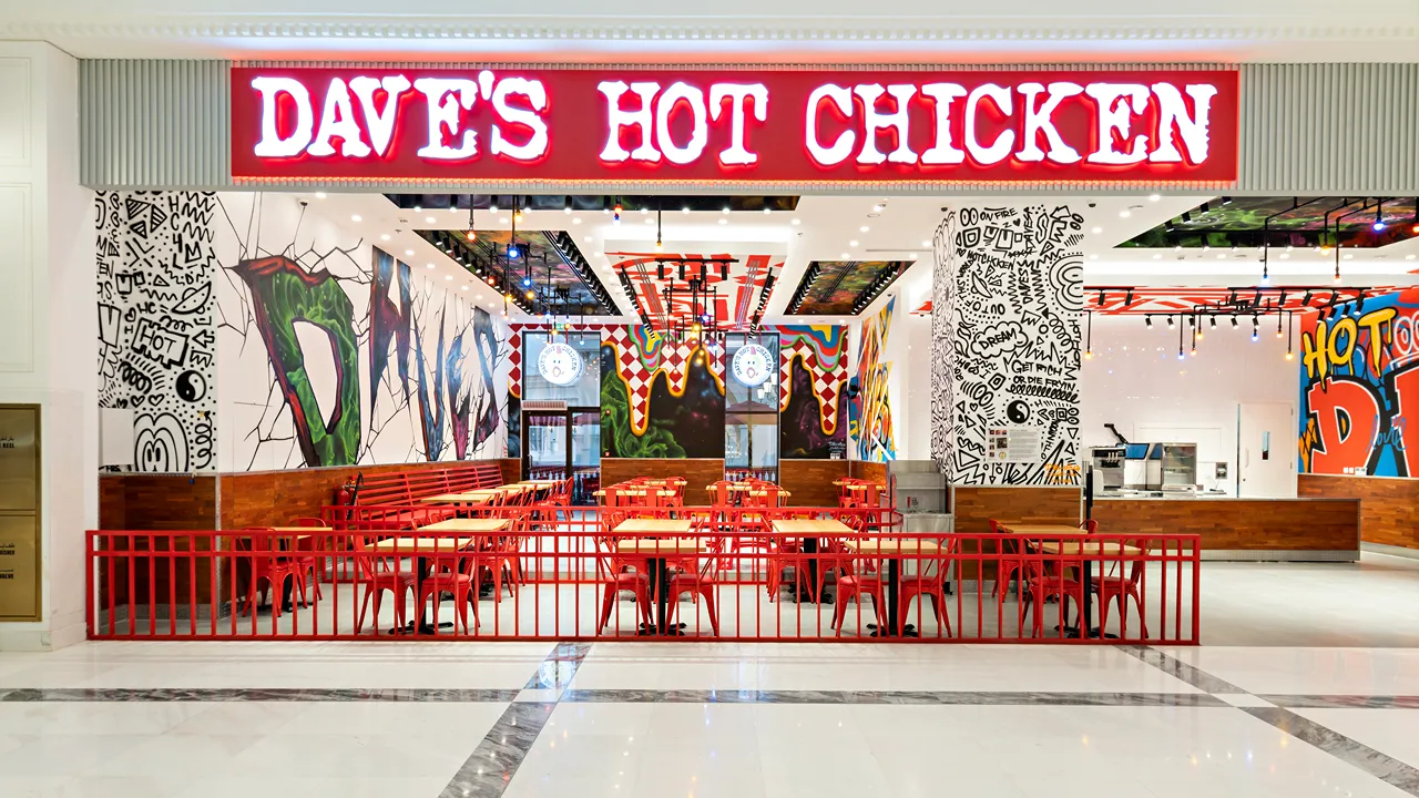 Exterior view of Dave’s Hot Chicken at Place Vendôme Mall in Lusail City, near Doha, Qatar, showcasing the iconic red signage and entrance.