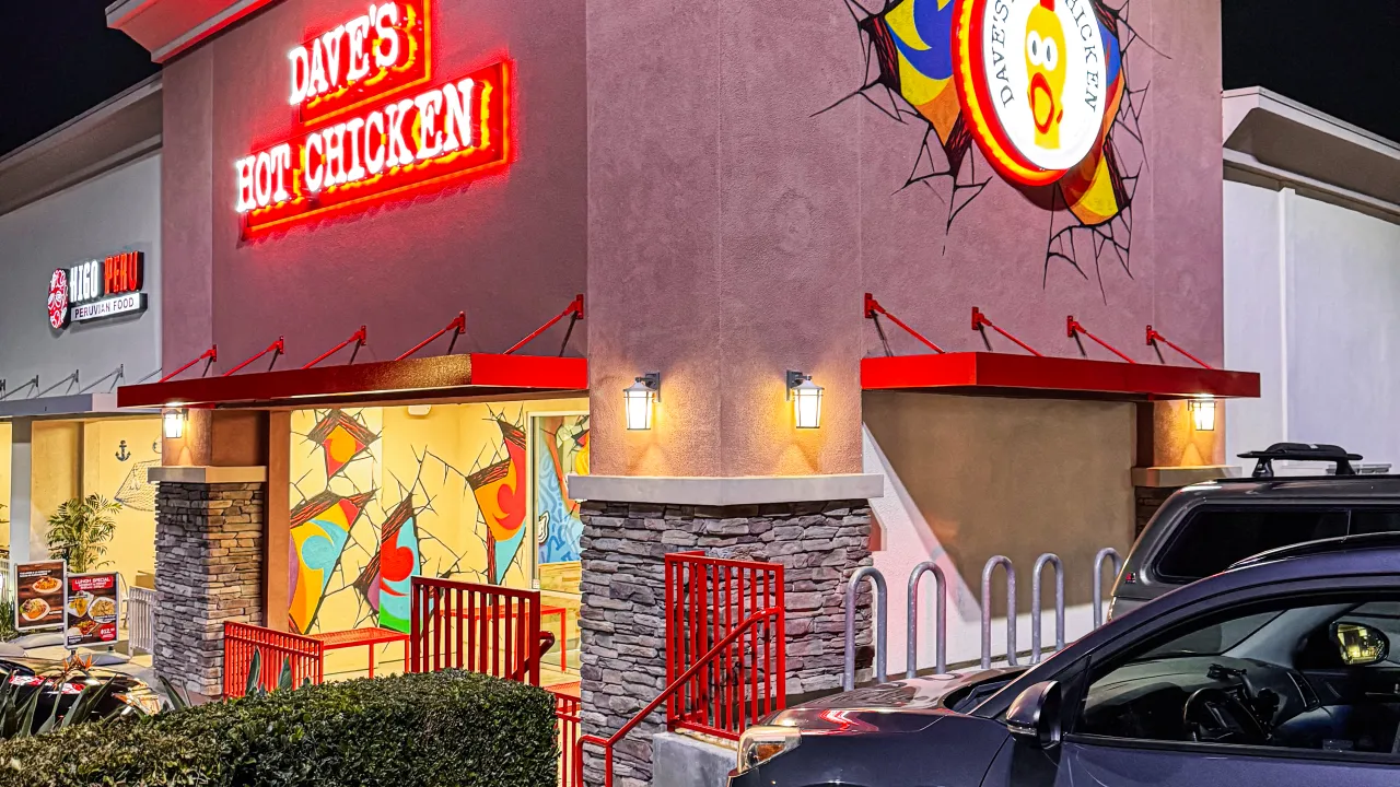 Exterior view of Dave's Hot Chicken on Colima Rd, Rowland Heights, CA, showcasing vibrant signage and colorful murals.