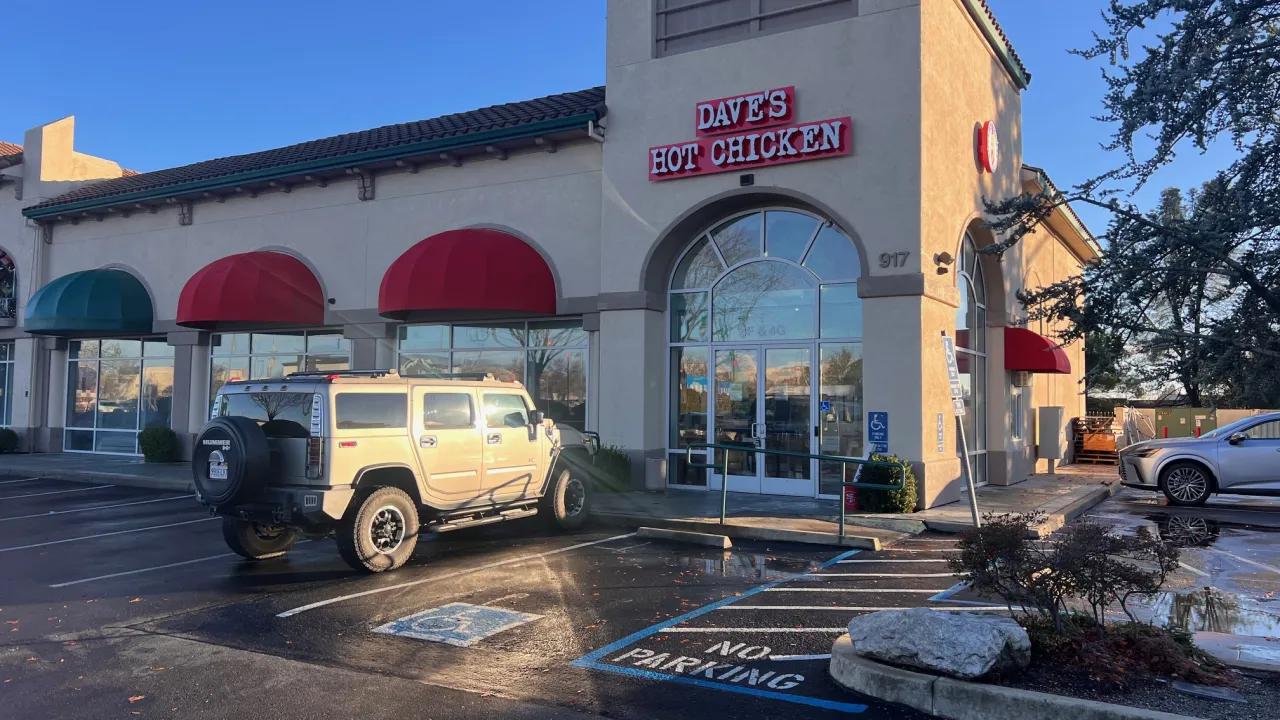 Exterior view of Dave's Hot Chicken at 917 Dana Dr, Redding, CA, showcasing red awnings and prominent signage.