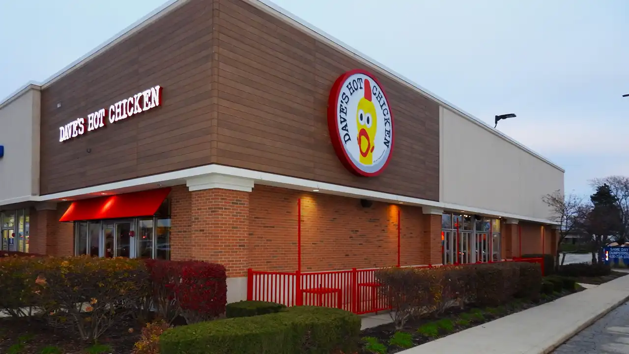 Exterior view of Dave’s Hot Chicken on LaGrange Rd, Orland Park, Illinois, with the logo and signature red accents.