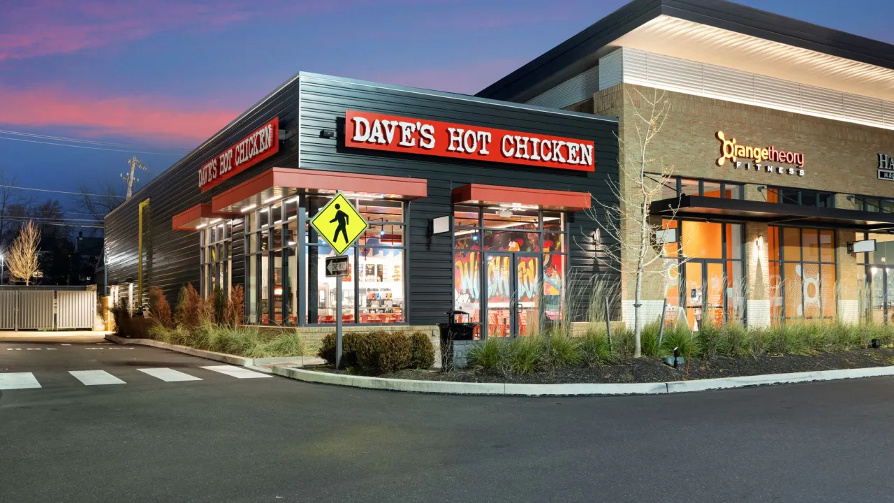 Exterior view of Dave's Hot Chicken on Park Ave, Willow Grove, PA, showcasing vibrant signage and colorful murals.