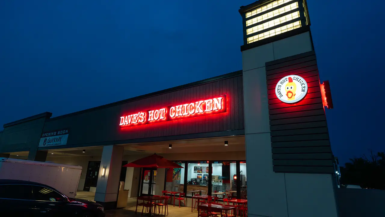 Exterior photo of a Dave's Hot Chicken in Glen Burnie, MD at night.