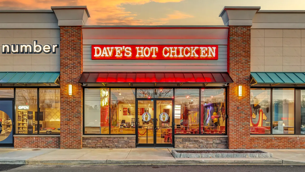 Exterior view of Dave's Hot Chicken on Boston Post Rd, Milford, CT, showcasing vibrant signage and welcoming entrance.