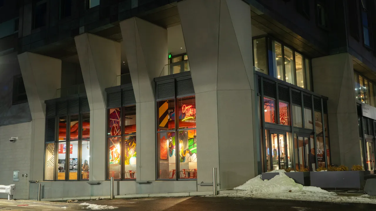 Exterior view of Dave’s Hot Chicken on Boylston Street, Boston, MA, showcasing vibrant murals and welcoming signage.