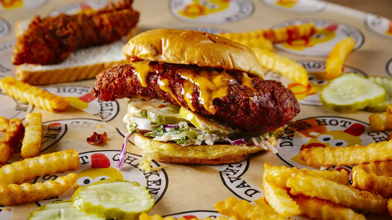 Delicious Dave's Hot Chicken sandwich with crinkle fries on a branded paper, 4213 First St, Livermore, CA.