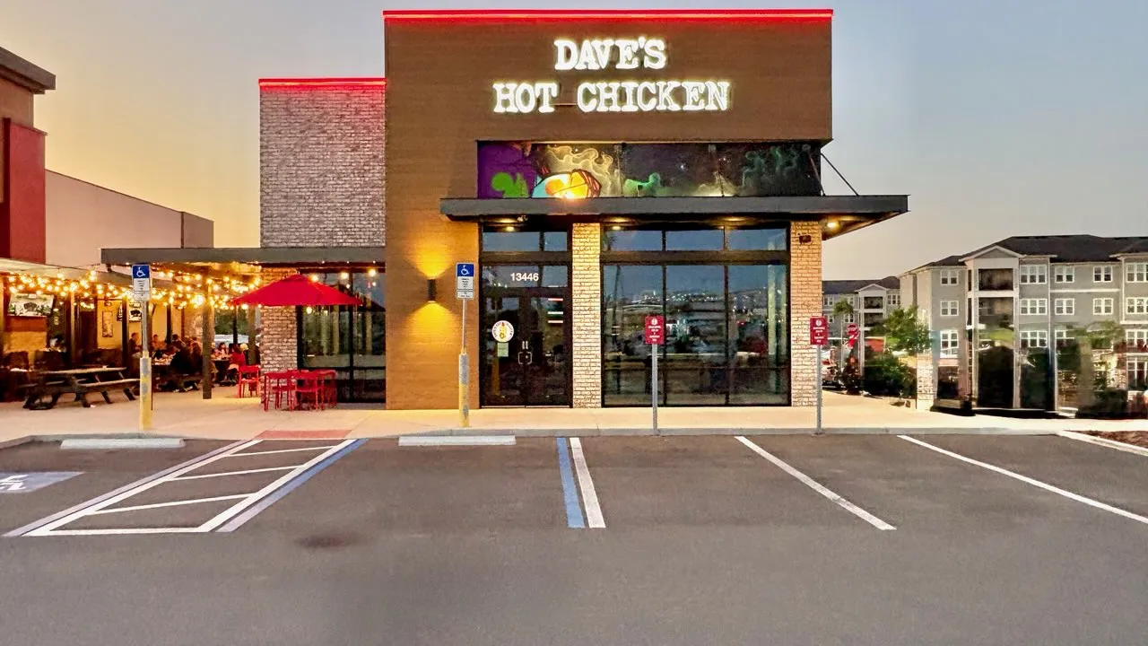 Exterior view of Dave's Hot Chicken at 13446 Pine Gap Spur, Odessa, FL, showcasing vibrant signage and outdoor seating.
