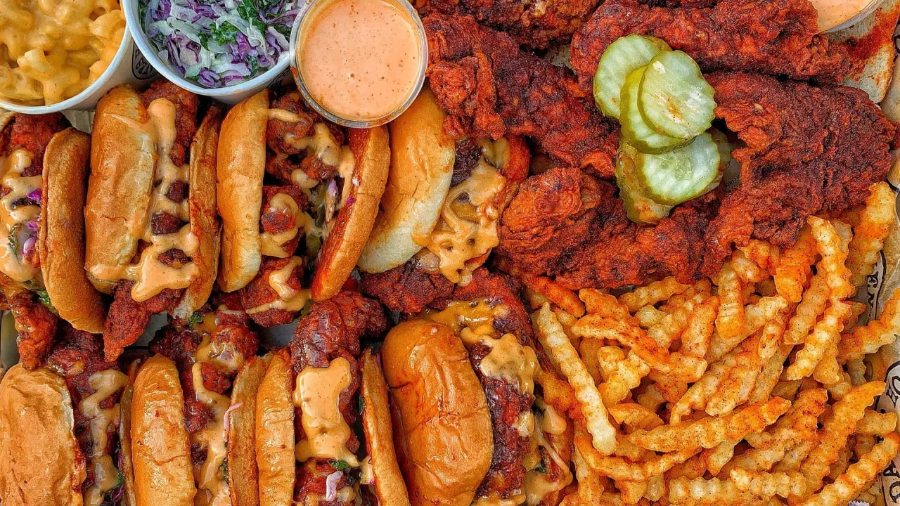 Delicious spread of Dave's Hot Chicken featuring spicy chicken sandwiches, crinkle fries, and sides, Odessa, FL.