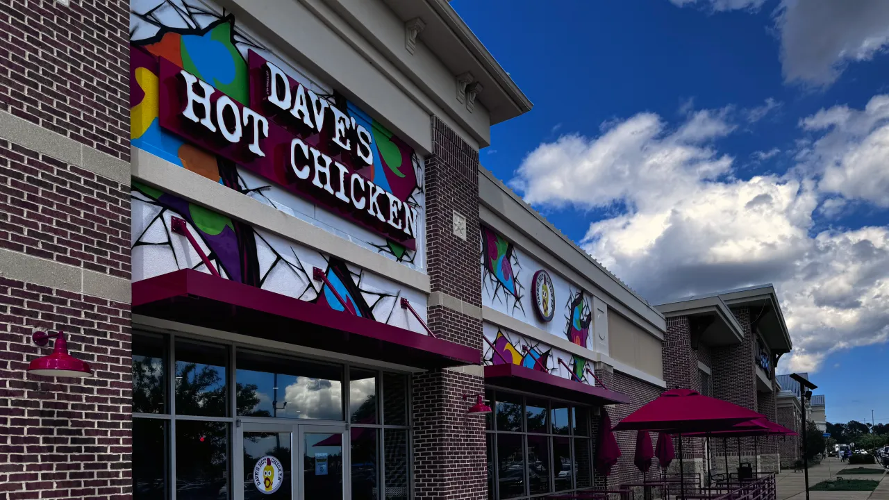 Exterior view of Dave's Hot Chicken at 10261 River Marsh Dr, Jacksonville, FL, showcasing colorful murals and outdoor seating.