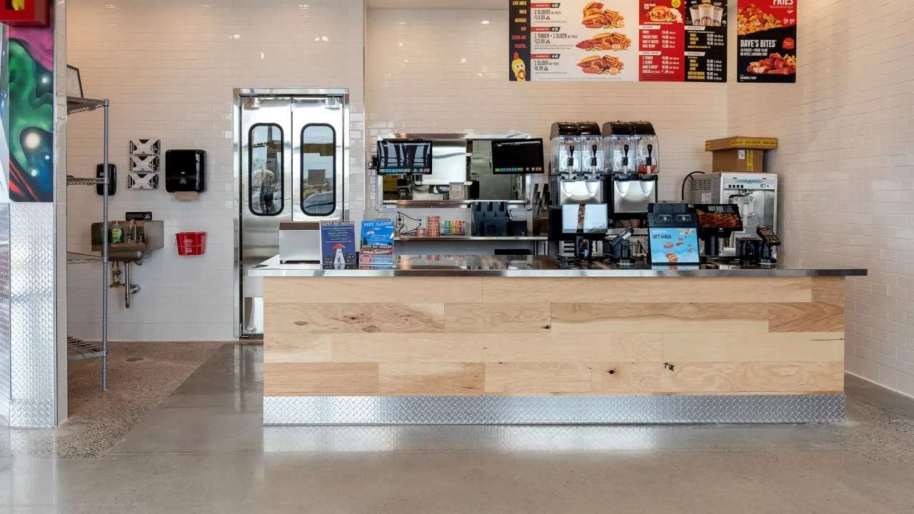 Interior view of the ordering counter at Dave's Hot Chicken, 218 N West End Blvd, Quakertown, PA, featuring sleek decor and menu signage.