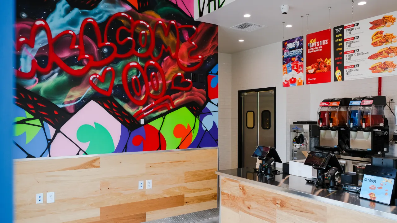 Interior view of Dave's Hot Chicken at 1501 Quentin Rd, Lebanon, PA, showcasing vibrant mural and modern counter design.