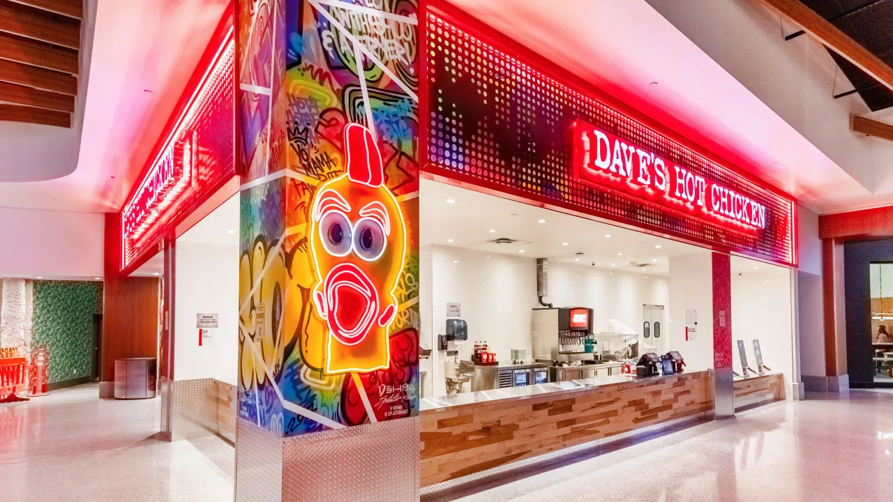 Interior view of Dave's Hot Chicken at 3623 Las Vegas Blvd S, Las Vegas, NV, showcasing vibrant murals and bright signage.