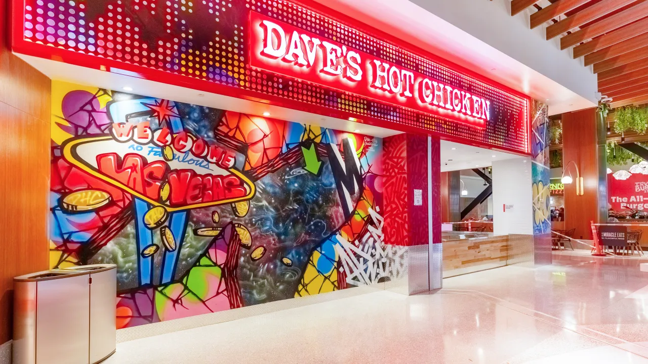 Interior view of Dave's Hot Chicken at 3623 Las Vegas Blvd S, Las Vegas, NV, showcasing vibrant murals and bold signage.