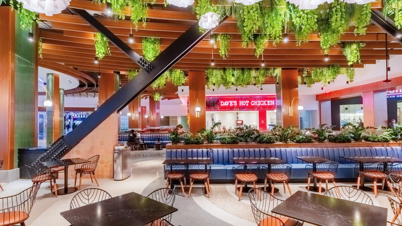 Interior view of Dave’s Hot Chicken at 3623 Las Vegas Blvd S, Las Vegas, NV, featuring lush greenery and modern seating.