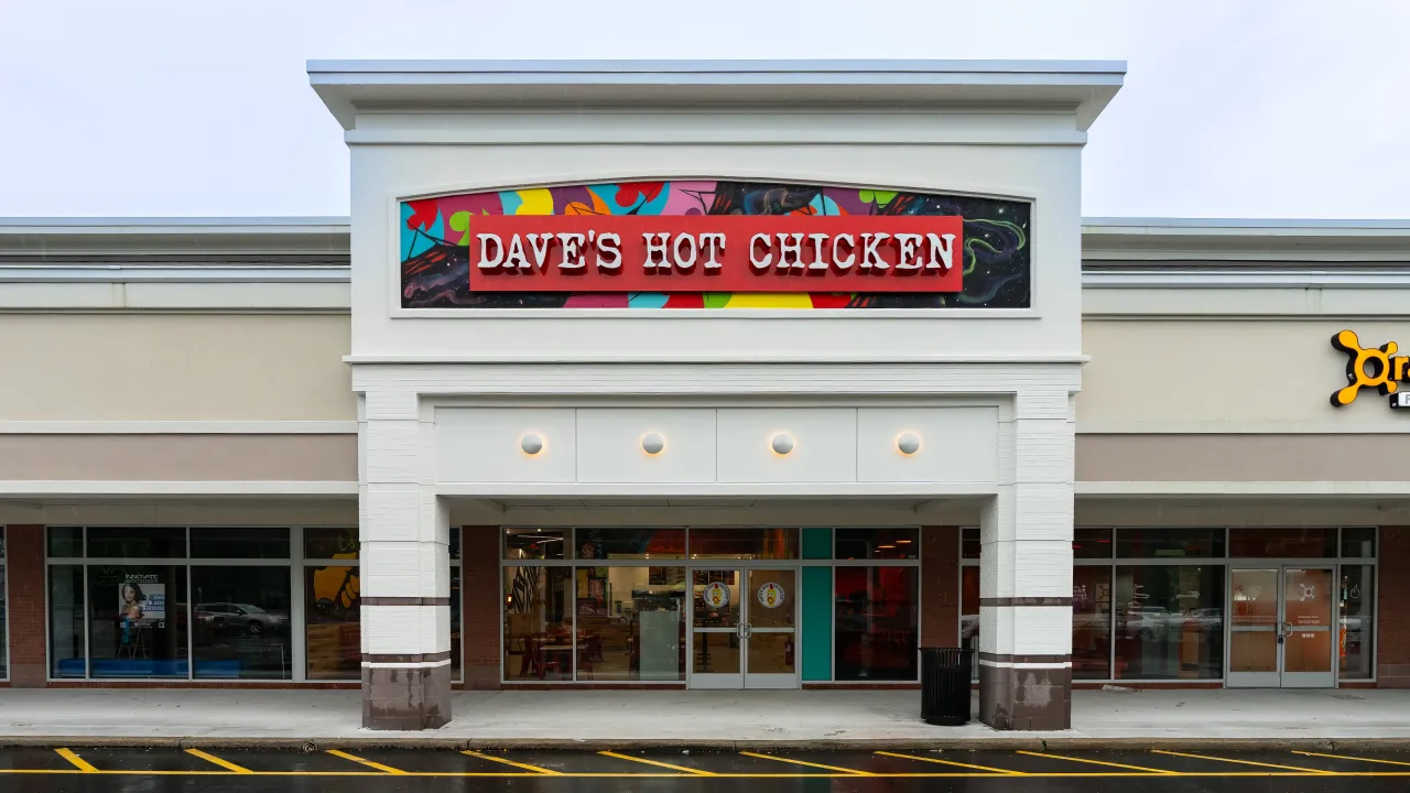 Exterior view of Dave's Hot Chicken on NJ-70 W, Brick, NJ, featuring vibrant signage and a modern storefront.
