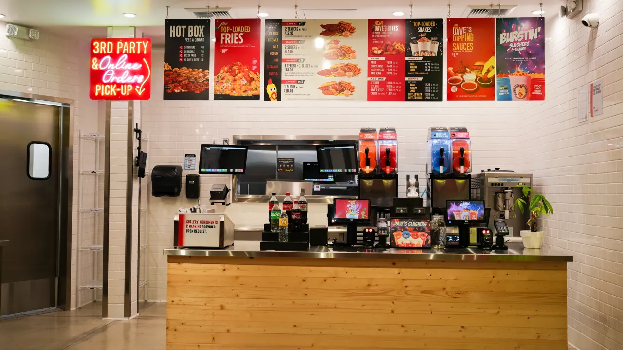 Interior view of Dave's Hot Chicken on South Indian Hill Blvd, Claremont, CA, showcasing the order counter and vibrant menu.