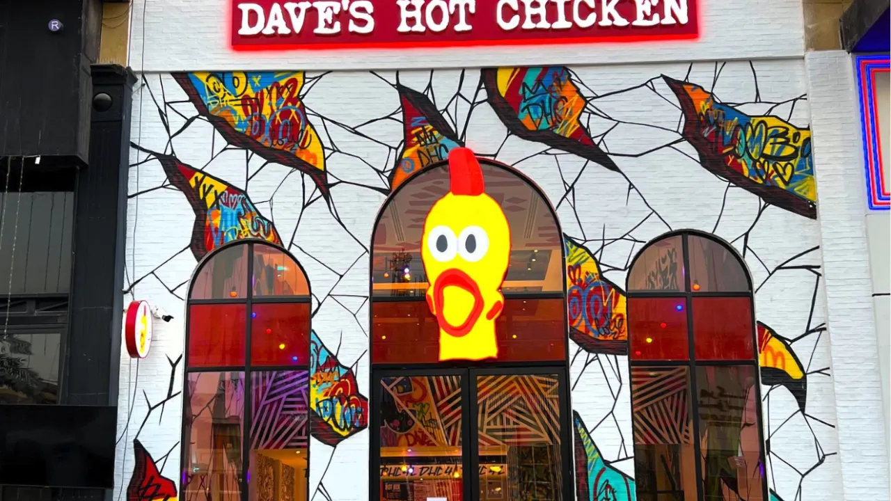 Exterior view of Dave's Hot Chicken on Prince Muhammad Ibn Abd Al Aziz, Riyadh, KSA, showcasing vibrant murals and signage.