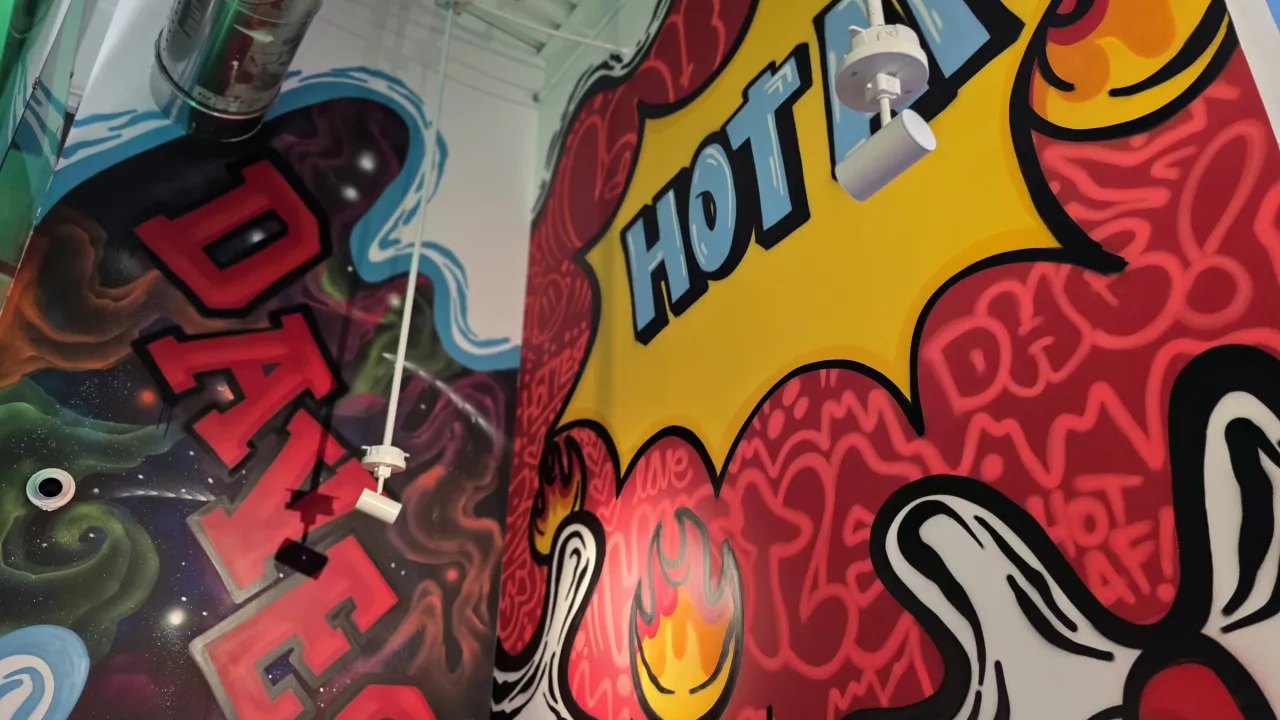Interior shot of vibrant mural at Dave's Hot Chicken, 2920 Sherman Oak Place, Raleigh, NC, featuring bold colors and graphics.