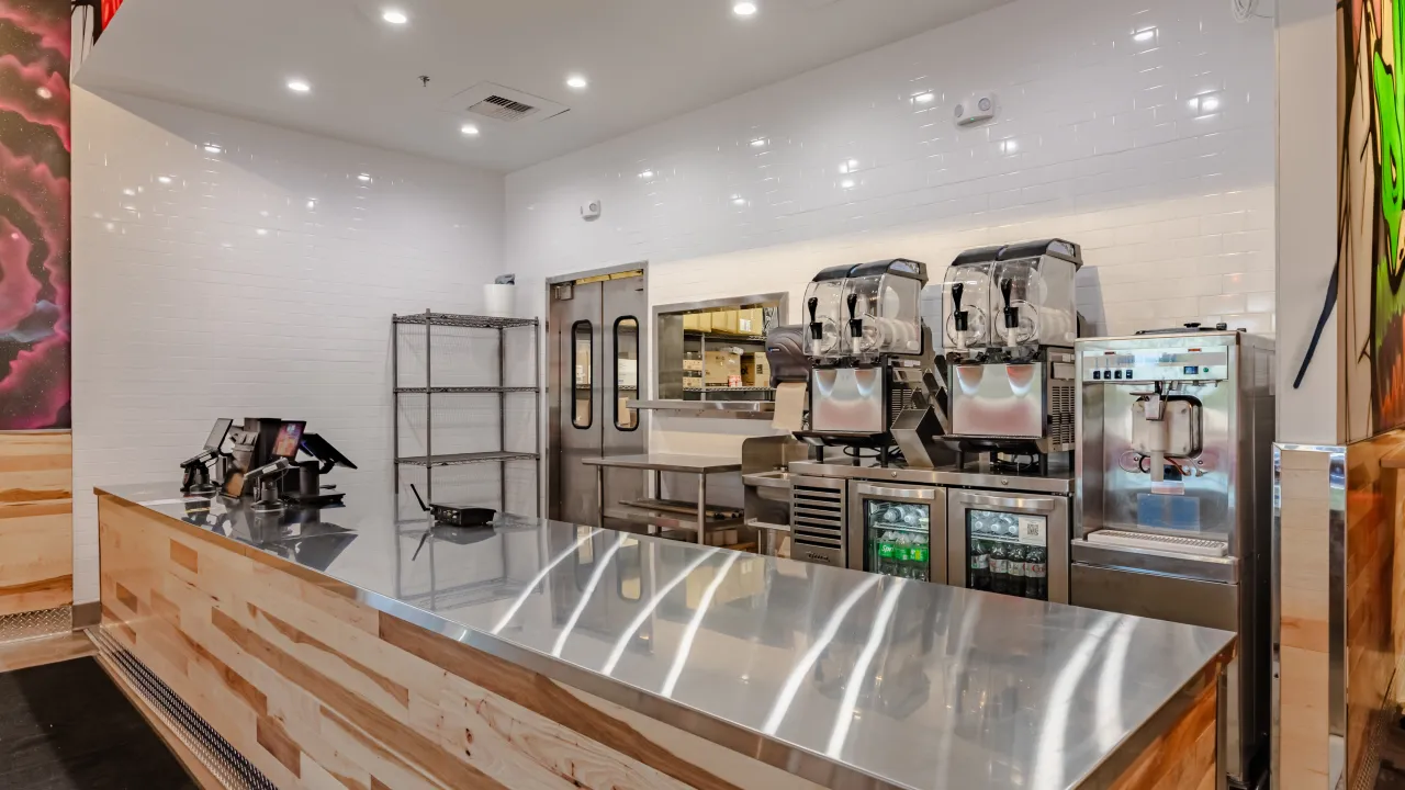 Interior view of Dave's Hot Chicken at 7413 Eastchase Pkwy, Montgomery, AL, showcasing the sleek counter and drink machines.