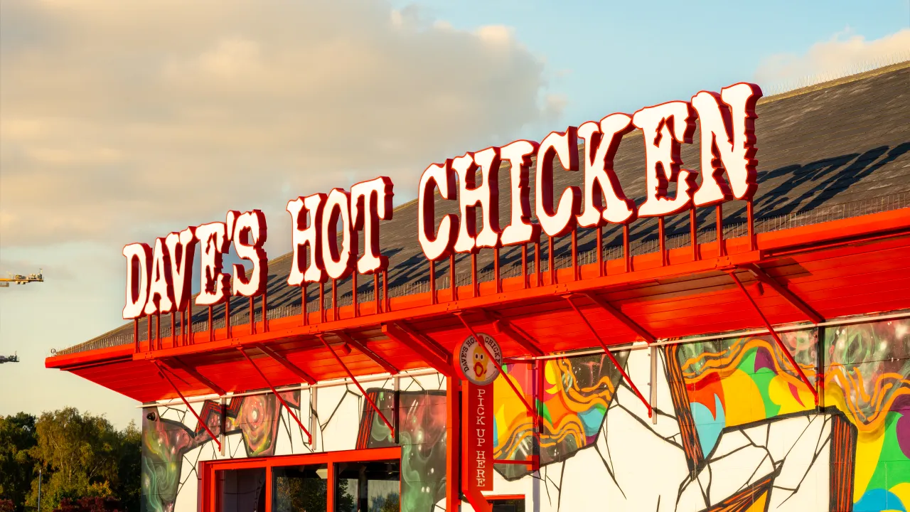 Exterior view of Dave's Hot Chicken at Stevenage Leisure Park, Stevenage, SG1 2UA, showcasing vibrant signage and colorful murals.