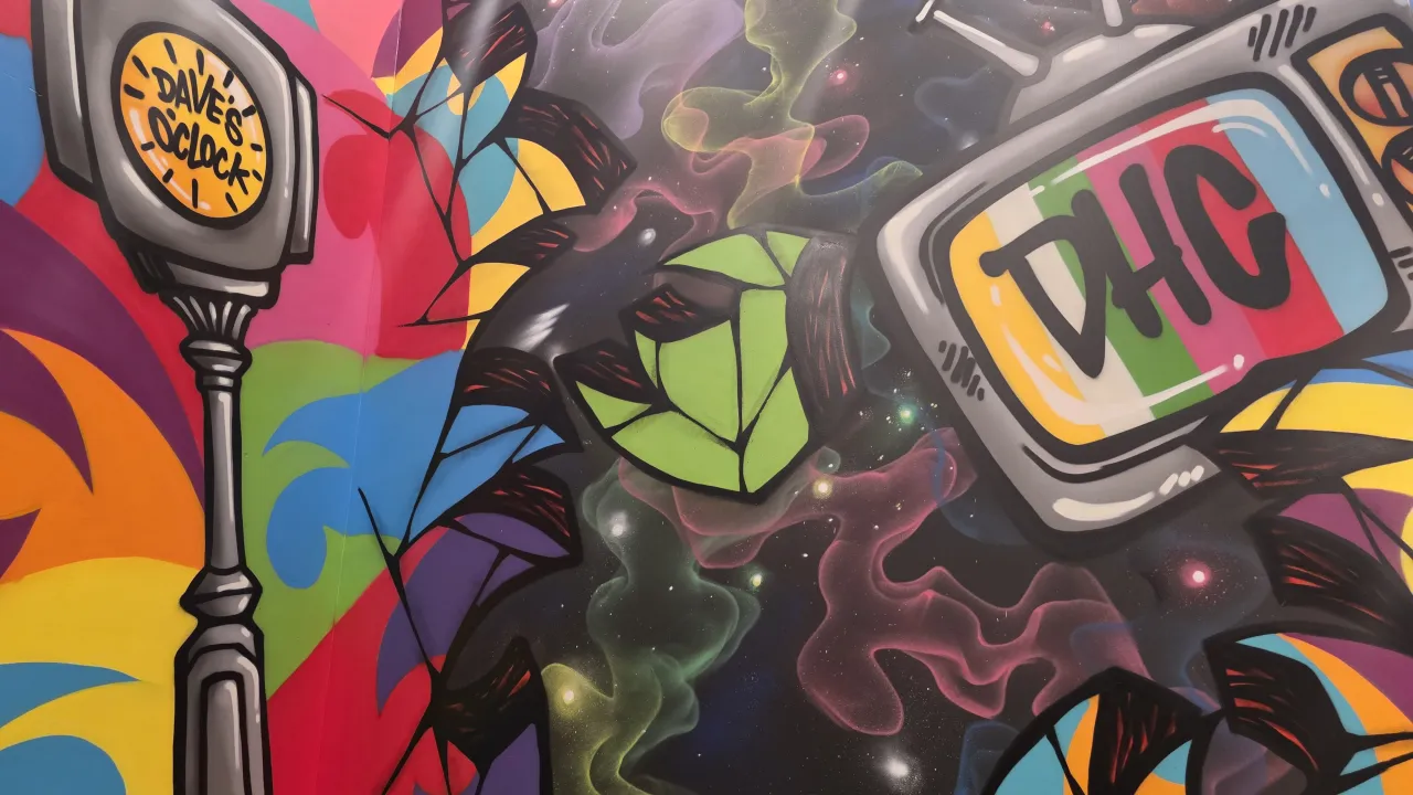 Vibrant mural featuring colorful designs and Dave's clock at Dave's Hot Chicken, 412 Balltown Rd, Schenectady, NY.