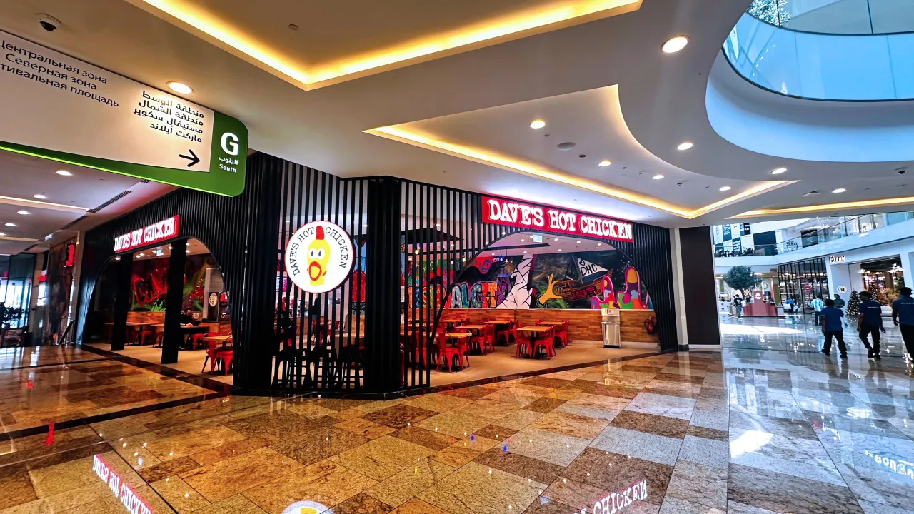 Exterior view of Dave’s Hot Chicken on Crescent Drive St, Dubai Festival City, Dubai, showcasing vibrant murals and bold signage.